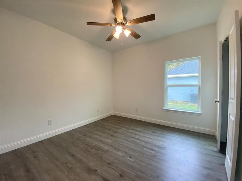 Bedroom with dark wood-style flooring and ceiling fan Bedroom with dark wood-style flooring and ceiling fan