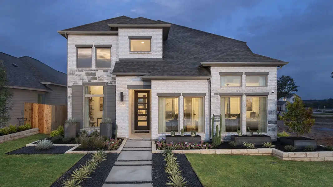 Front exterior of a new home in Santa Rita Ranch Tierra Rosa, Liberty Hill, TX, highlighting curb appeal (Image 2).