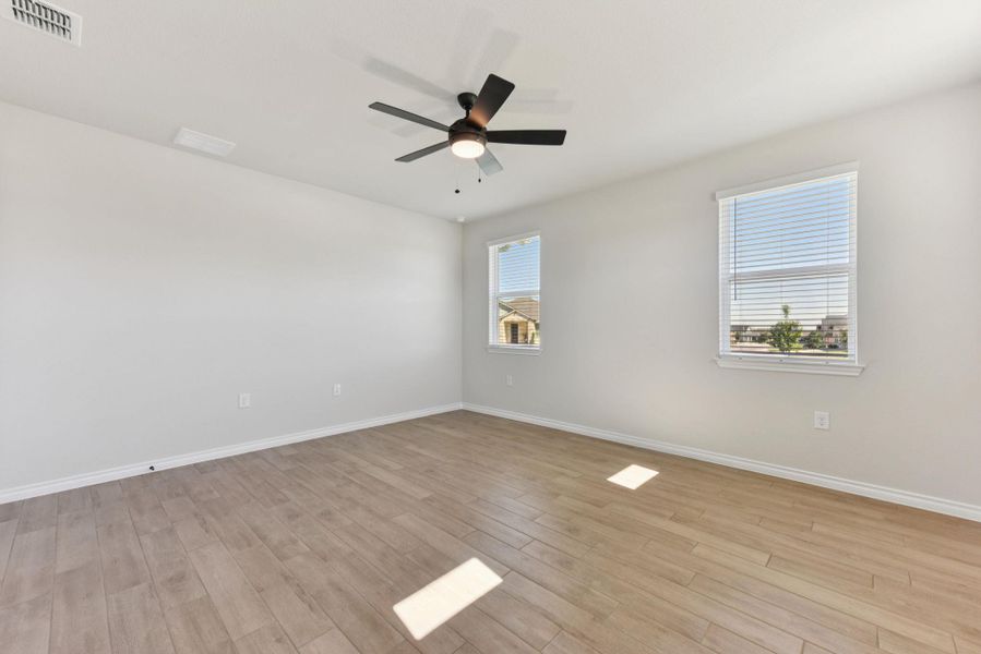 Unfurnished room featuring light wood finished floors and ceiling fan