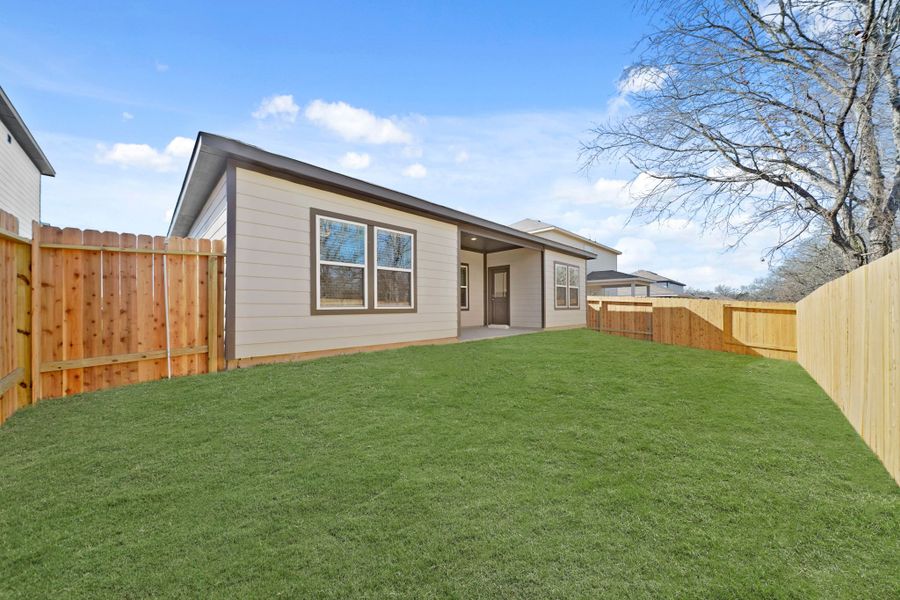 A house with a fence and grass. A house with a fence and grass.
