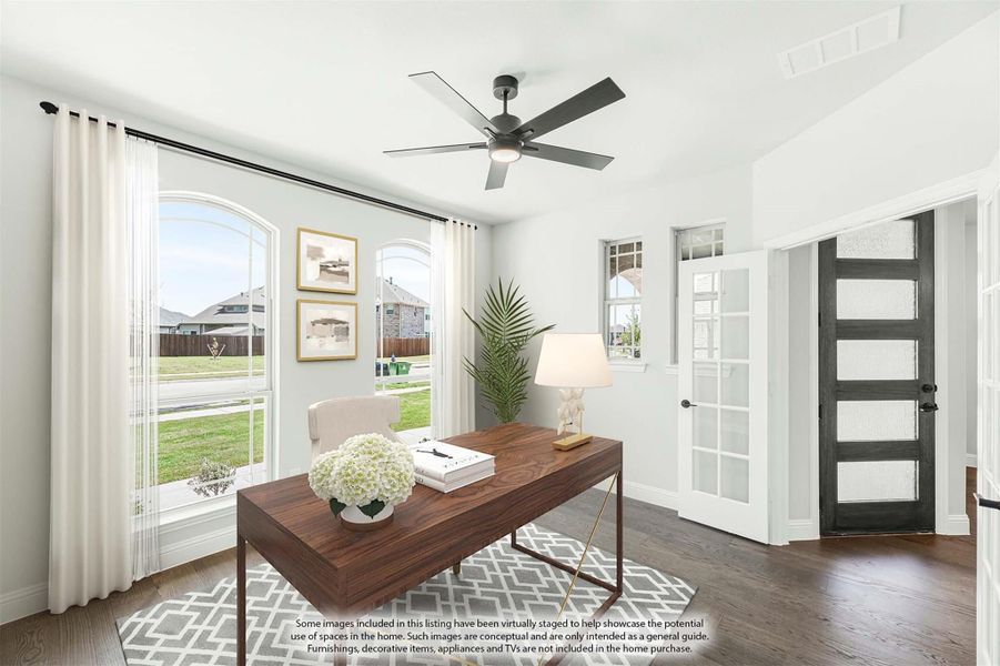 Home office with wood desk, ceiling fan, arched windows, and dark hardwood floors Home office with wood desk, ceiling fan, arched windows, and dark hardwood floors