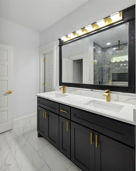 Bathroom with vanity and tiled shower