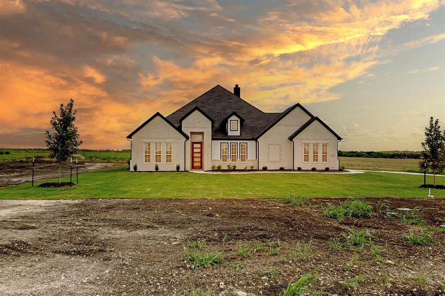 French provincial home featuring a yard