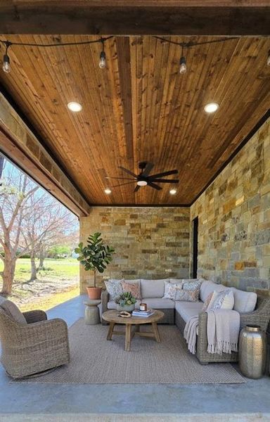 View of patio with outdoor lounge area and ceiling fan AI staged* View of patio with outdoor lounge area and ceiling fan AI staged*