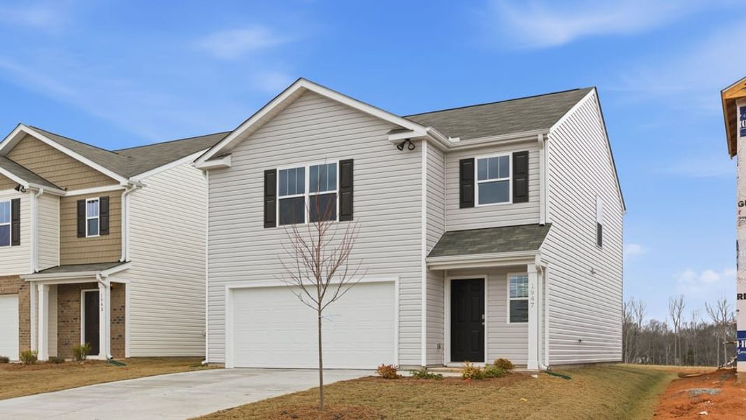 Front exterior of a new home in Harrier Point, Woodruff, SC, highlighting curb appeal (Image 1). Front exterior of a new home in Harrier Point, Woodruff, SC, highlighting curb appeal (Image 1).