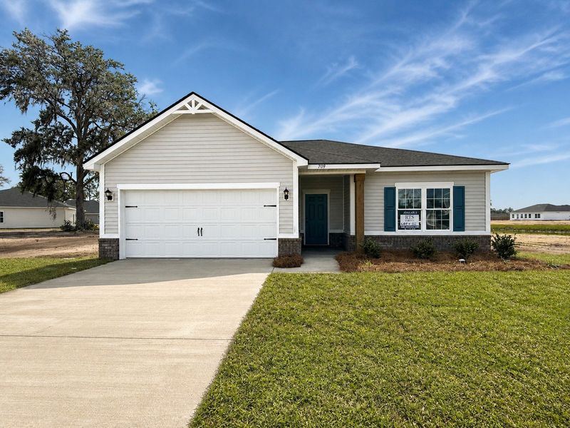Front exterior of a new home in The Village at Sassafras, Allenhurst, GA, highlighting curb appeal (Image 1). Front exterior of a new home in The Village at Sassafras, Allenhurst, GA, highlighting curb appeal (Image 1).