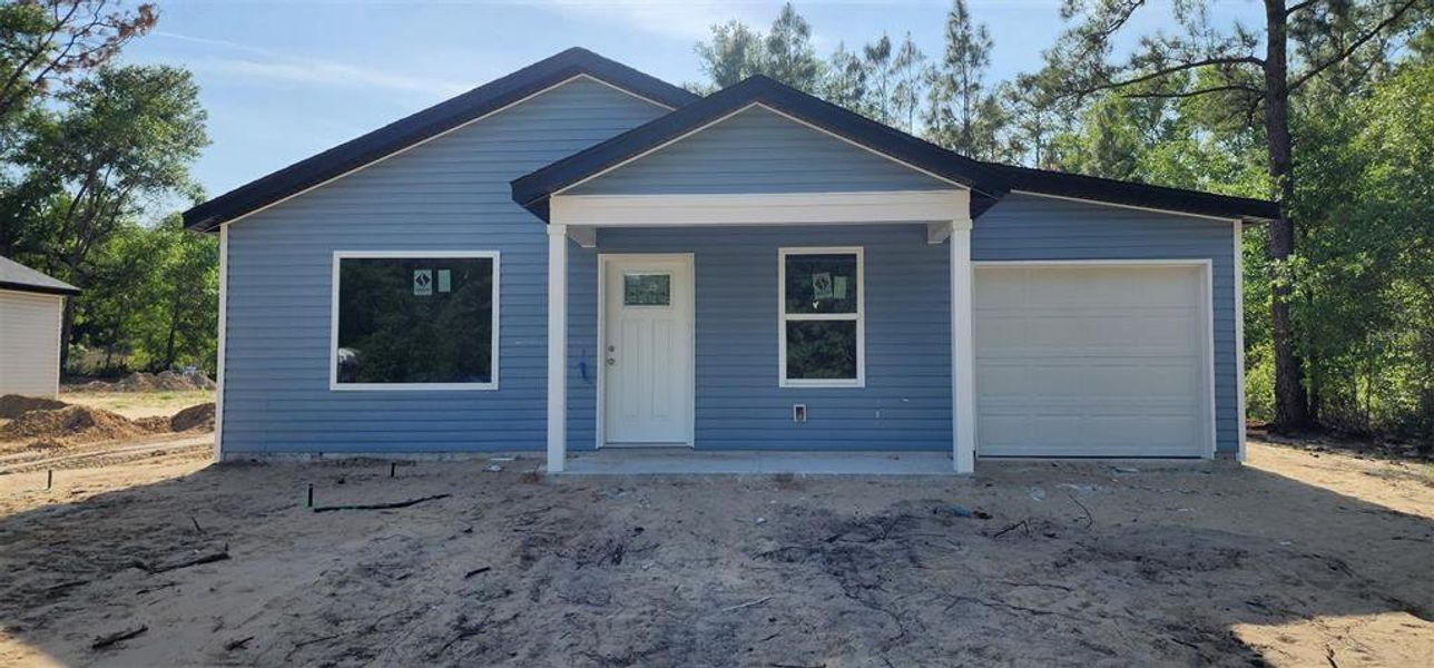Front exterior of a new home in , Ocala, FL, highlighting curb appeal (Image 1).