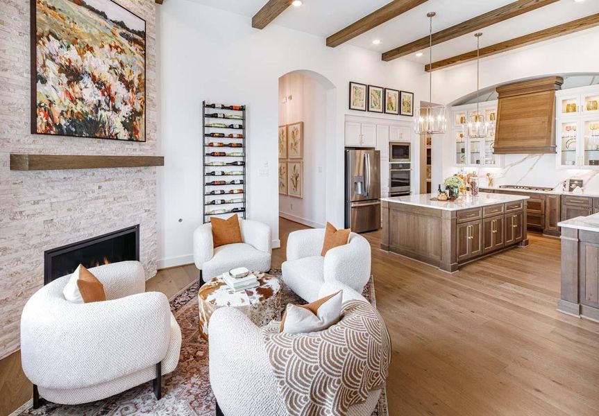 Keeping Room or additional sitting area has a gorgeous fireplace open to the rest of the main living space.