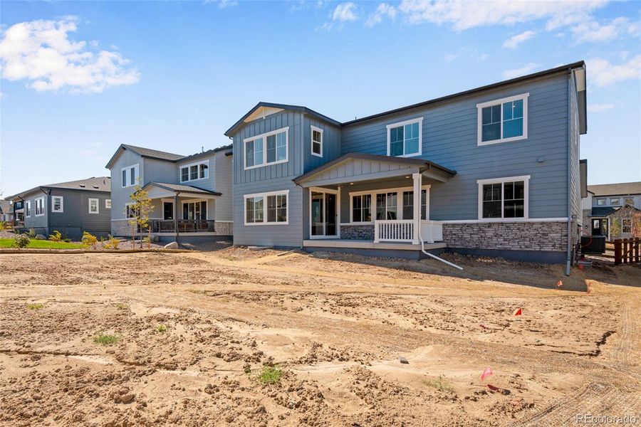 Front exterior of a new home in Ensemble at The Aurora Highlands, Aurora, CO, highlighting curb appeal (Image 25). Front exterior of a new home in Ensemble at The Aurora Highlands, Aurora, CO, highlighting curb appeal (Image 25).