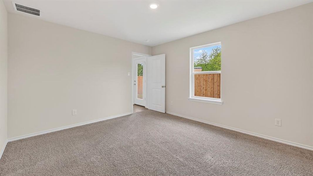 Carpeted room with neutral wall tones and a ceiling-mounted light fixture