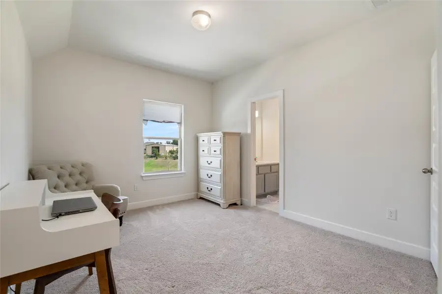This bedroom features a high ceiling and closet space.