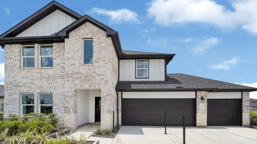 Front exterior of a new home in Evergreen, Rosenberg, TX, highlighting curb appeal (Image 1). Front exterior of a new home in Evergreen, Rosenberg, TX, highlighting curb appeal (Image 1).