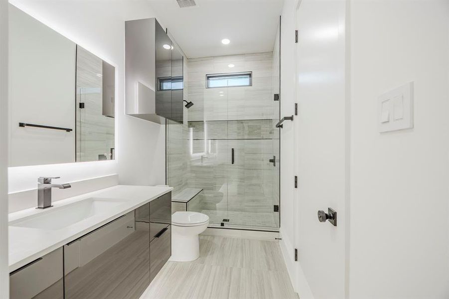 Bathroom featuring vanity, a shower stall, and recessed lighting Bathroom featuring vanity, a shower stall, and recessed lighting