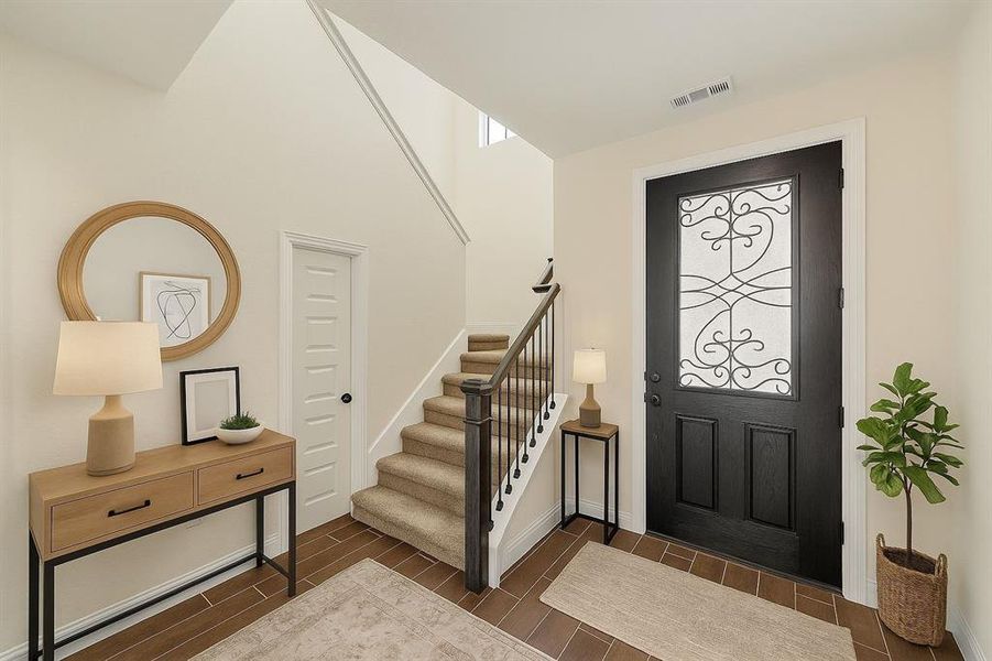 Entrance foyer with wood finish floors and stairway virtually staged Entrance foyer with wood finish floors and stairway virtually staged