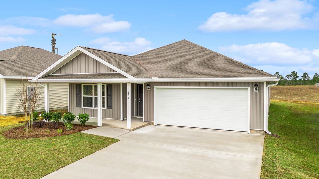 Front exterior of a new home in Magnolia at the Bluffs Phase 3, Freeport, FL, highlighting curb appeal (Image 2).