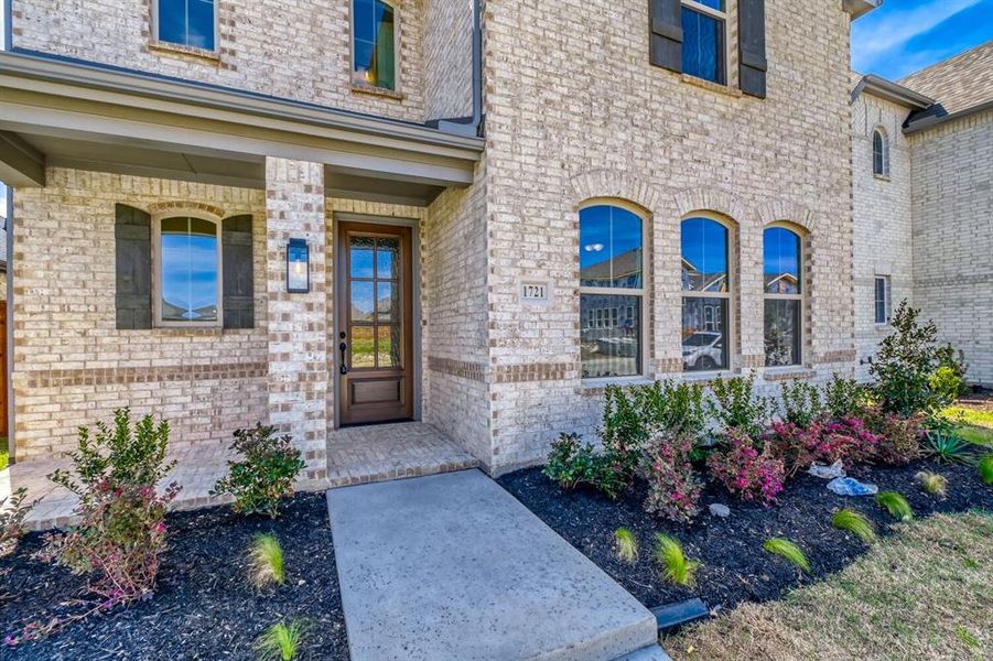 View of exterior entry featuring brick siding and a porch View of exterior entry featuring brick siding and a porch
