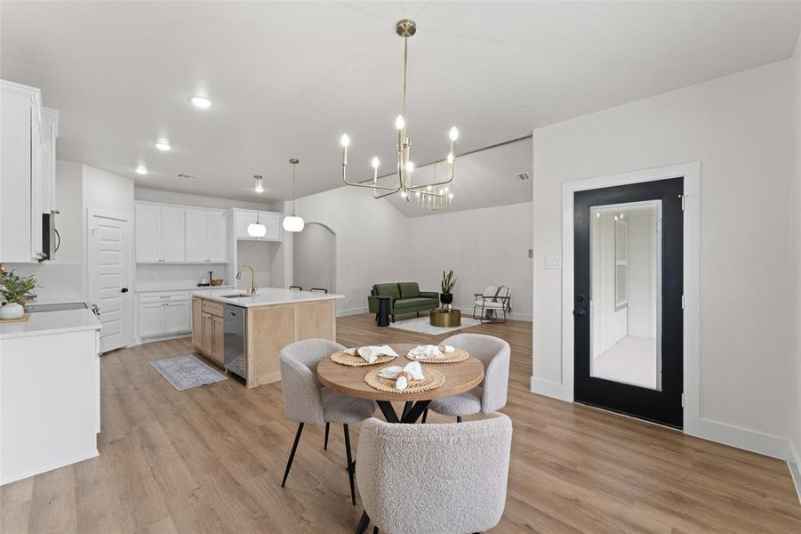 Dining space with a chandelier, light wood-style floors, recessed lighting, and baseboards Dining space with a chandelier, light wood-style floors, recessed lighting, and baseboards