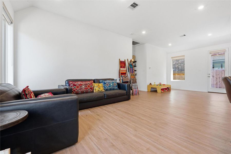 Large windows and a glass door provide plenty of natural light in this living room open area.