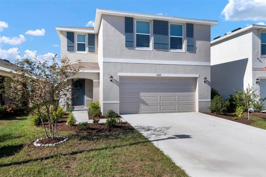 Front exterior of a new home in Bella Lago, Parrish, FL, highlighting curb appeal (Image 22).
