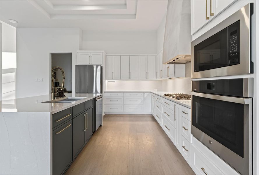 A spacious center island anchors the kitchen to provide excellent functionality. **Images are from a previously completed project. **