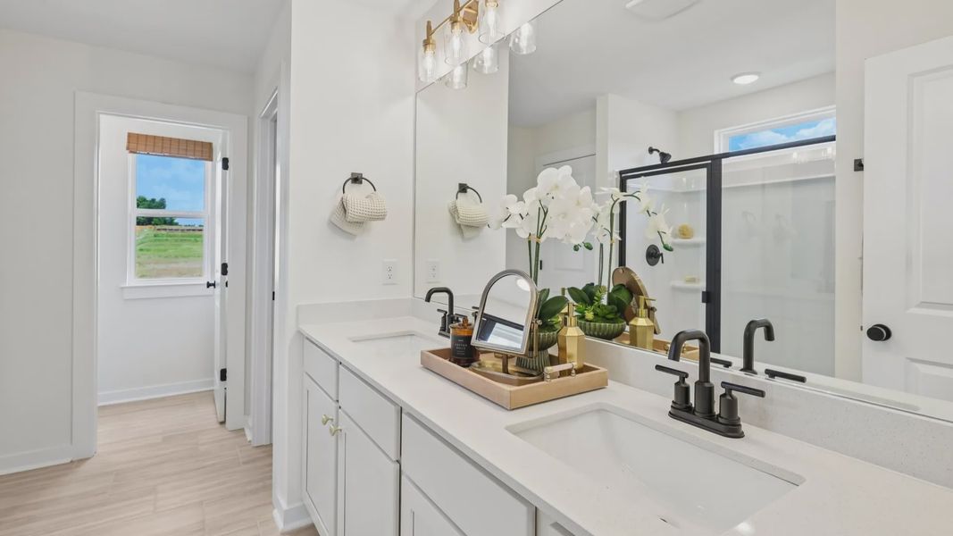 Primary bathroom with dual vanity and window