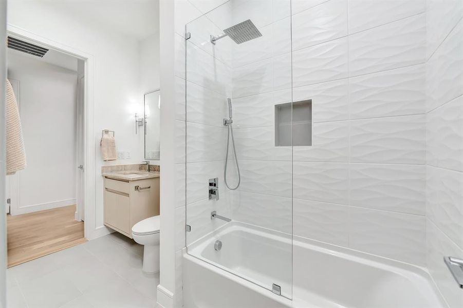 Full bathroom with vanity, tub / shower combination, and light tile patterned floors Full bathroom with vanity, tub / shower combination, and light tile patterned floors