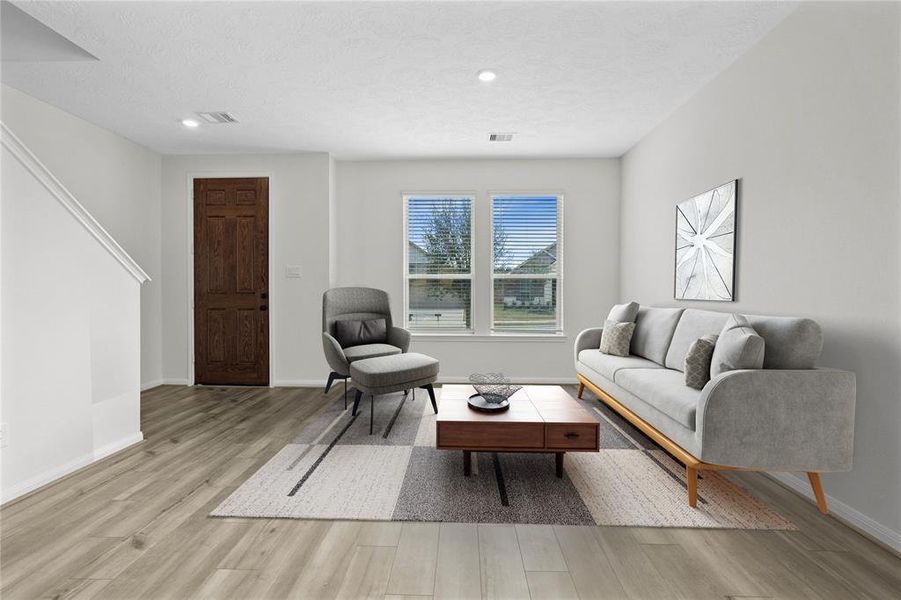 The front living room space can be used for your specific needs. This room features plenty of natural light with the windows and privacy blinds, recessed lighting, and gorgeous vinyl plank flooring!