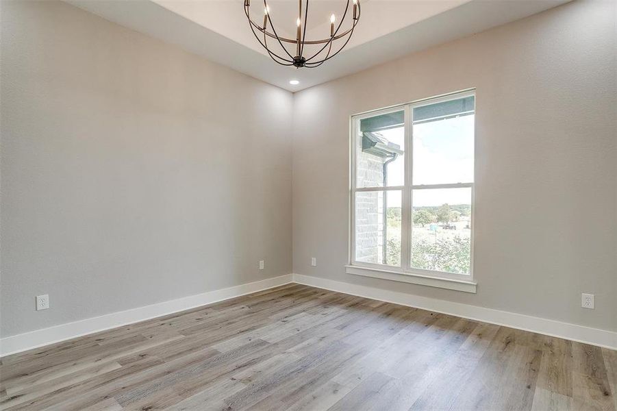 Dining room with a chandelier and light wood-type flooring