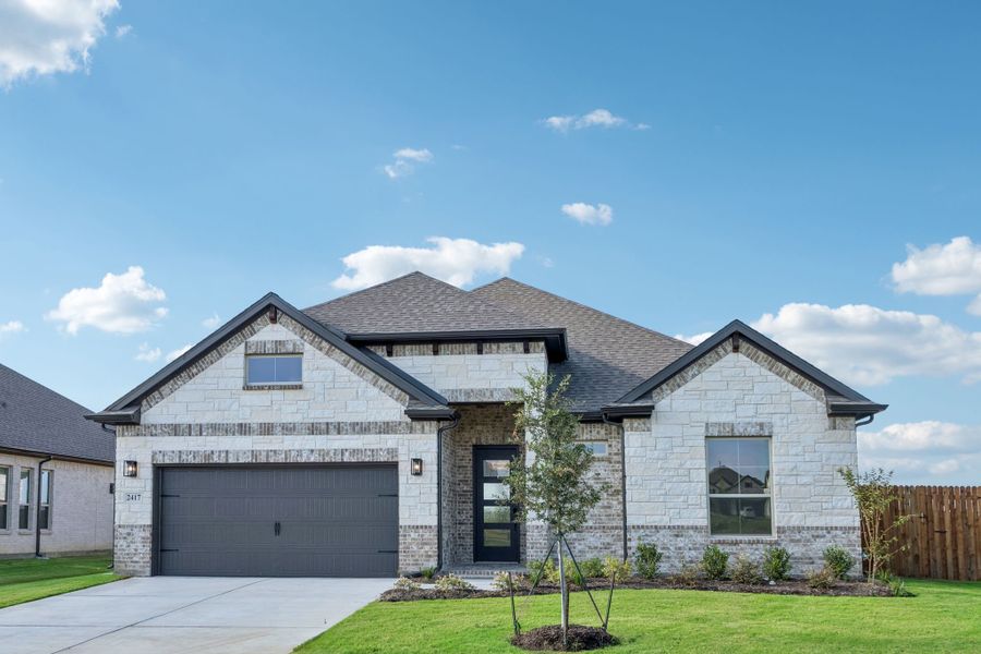 Front exterior of a new home in Sheppard's Place, Waxahachie, TX, highlighting curb appeal (Image 2). Front exterior of a new home in Sheppard's Place, Waxahachie, TX, highlighting curb appeal (Image 2).