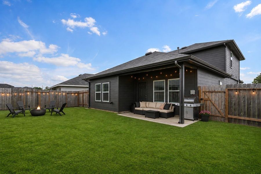 Covered patio overlooking a spacious backyard. Covered patio overlooking a spacious backyard.