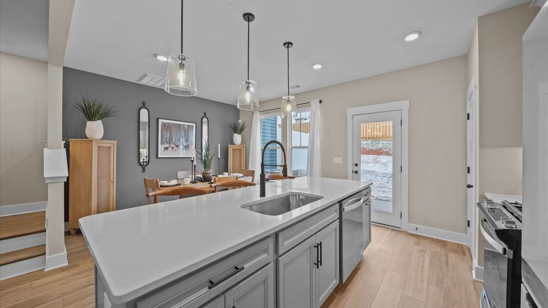 Exceptional culinary space with a striking 9-foot island and eye-catching pendant lights