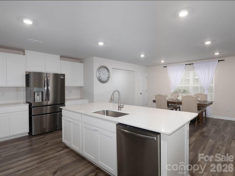 Gorgeous quartz countertops. Refrigerator conveys with sale.