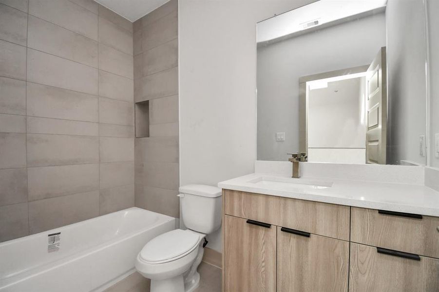 Full Bathroom 2 with Quartz Countertops and Tiled to Ceiling Walls