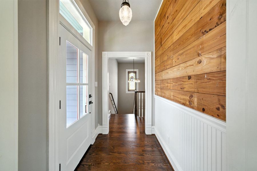Hallway with wainscoting and reclaimed shiplap features beautifully here! Door exits onto the second floor porch! Hallway with wainscoting and reclaimed shiplap features beautifully here! Door exits onto the second floor porch!