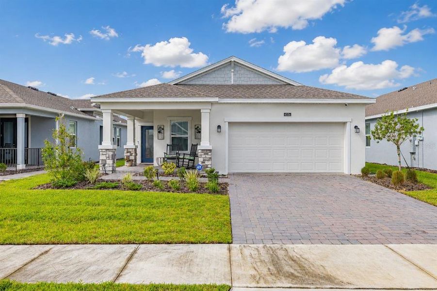 Front exterior of a new home in Lennar at Esplanade, Kissimmee, FL, highlighting curb appeal (Image 1). Front exterior of a new home in Lennar at Esplanade, Kissimmee, FL, highlighting curb appeal (Image 1).