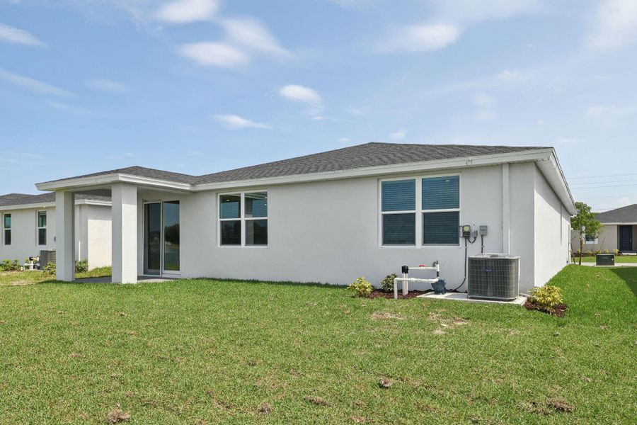 Front exterior of a new home in Hampton Park - Classic Series, Vero Beach, FL, highlighting curb appeal (Image 24).
