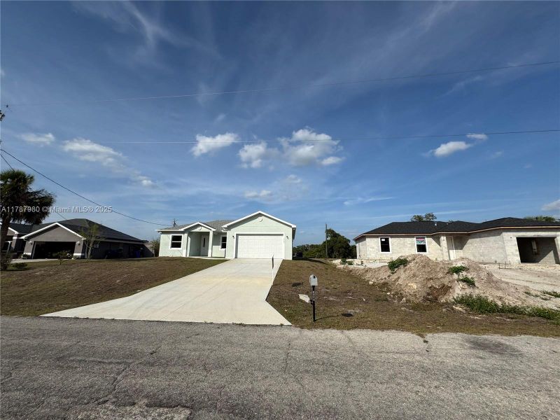 Front exterior of a new home in , Labelle, FL, highlighting curb appeal (Image 10).