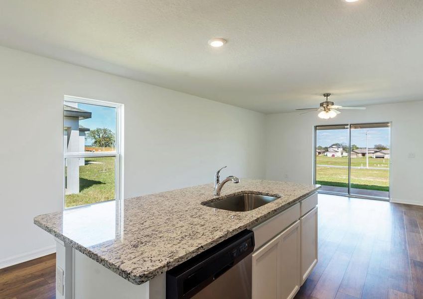 The kitchen island looks out over the entertainment space