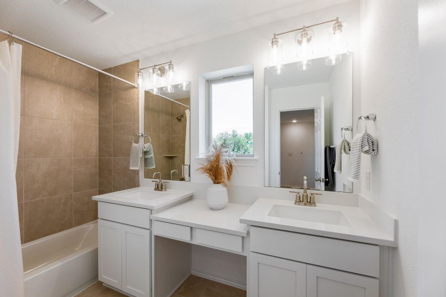 Full bathroom featuring double vanity and shower / bathtub combination with curtain