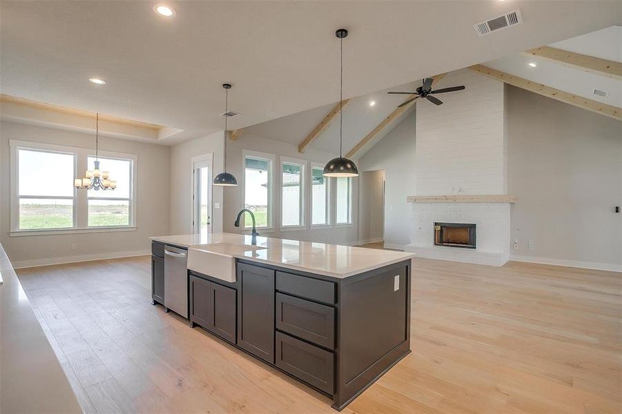 Kitchen with light wood-type flooring, plenty of natural light, visible vents, dishwasher, and a sink Kitchen with light wood-type flooring, plenty of natural light, visible vents, dishwasher, and a sink