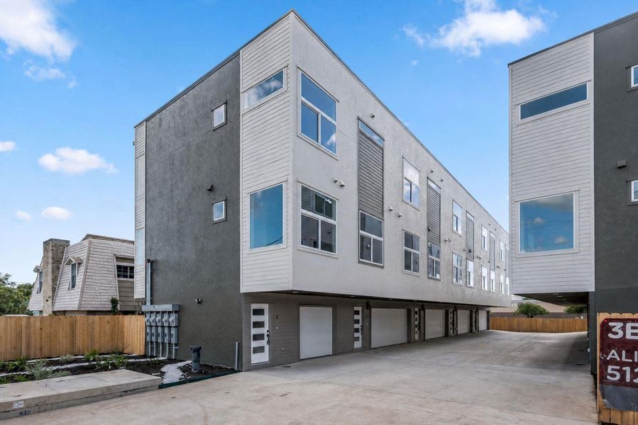 Clean lines and modern design define this multi-story property with ground-level garages.
