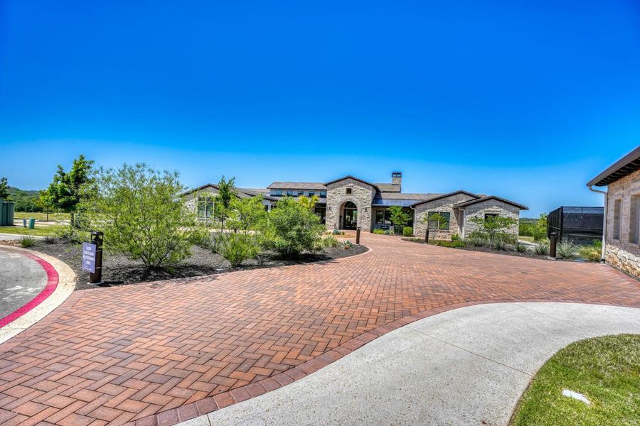 View of front of property with stone siding and a chimney