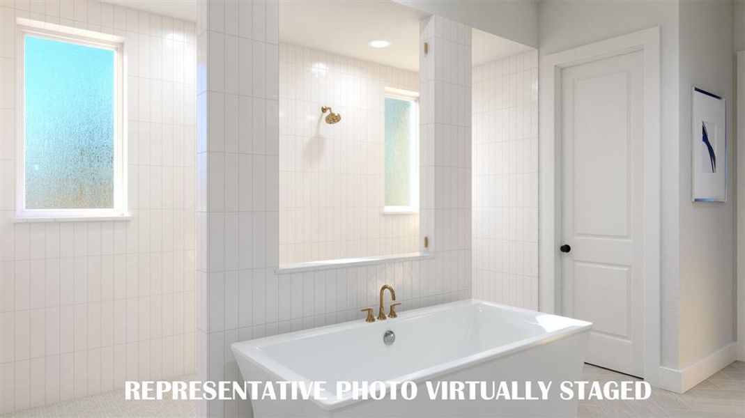Featuring a walk through double shower, drying space and a free standing tub, this owner's bath is one for the ages!  REPRESENTATIVE PHOTO VIRTUALLY STAGED