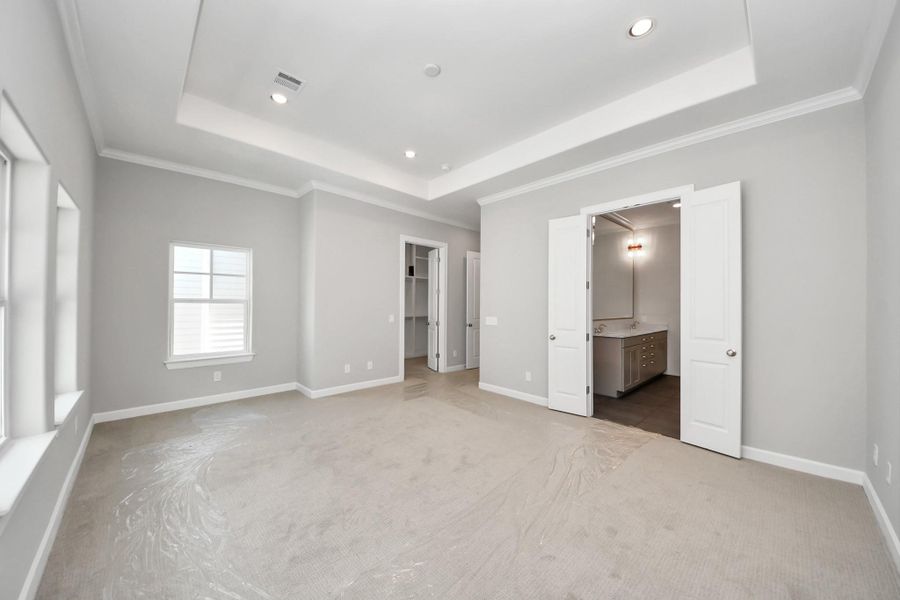 Spacious primary suite featuring recessed lighting and luxury finishes. Spacious primary suite featuring recessed lighting and luxury finishes.