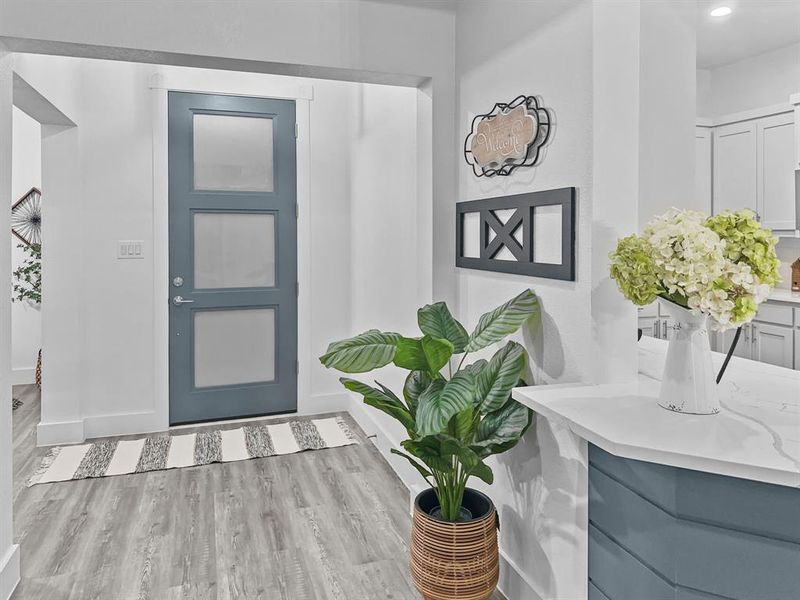 Entrance foyer with light hardwood / wood-style flooring