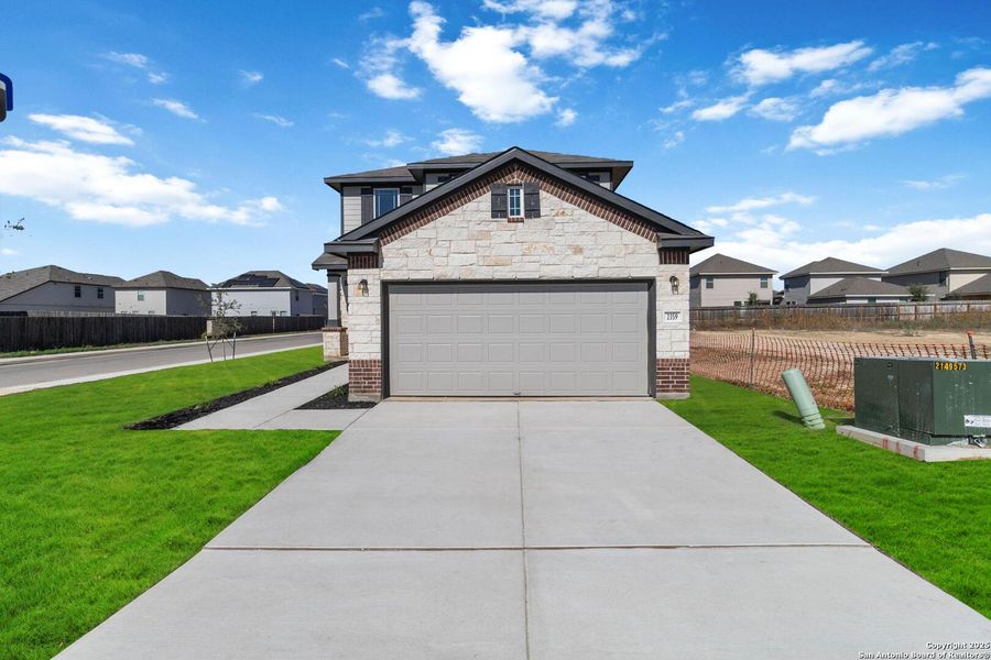 Front exterior of a new home in Applewhite Meadows, San Antonio, TX, highlighting curb appeal (Image 18). Front exterior of a new home in Applewhite Meadows, San Antonio, TX, highlighting curb appeal (Image 18).