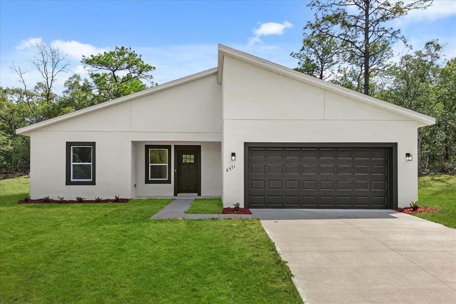 Front exterior of a new home in , Dunnellon, FL, highlighting curb appeal (Image 17).
