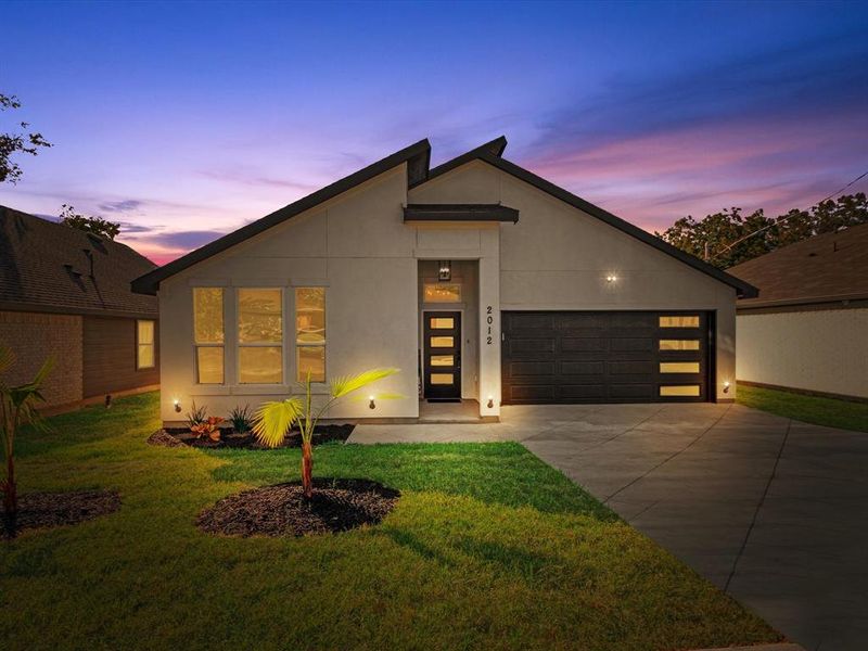 Contemporary house with a yard and a garage