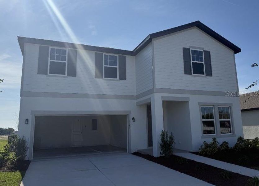 Front exterior of a new home in Tyson Reserve, St. Cloud, FL, highlighting curb appeal (Image 2).