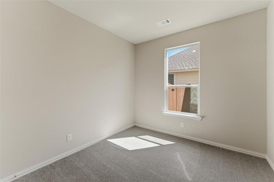 Unfurnished room featuring carpet and baseboards